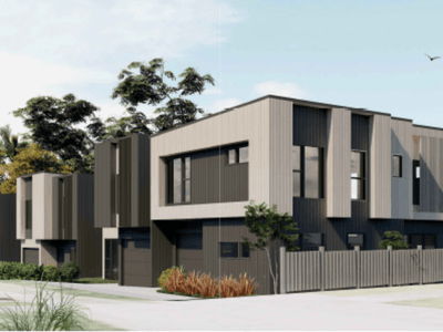 Modern two-story townhouses with gray and white siding, vertical accent panels, garages, and small front yards on a sunny day.