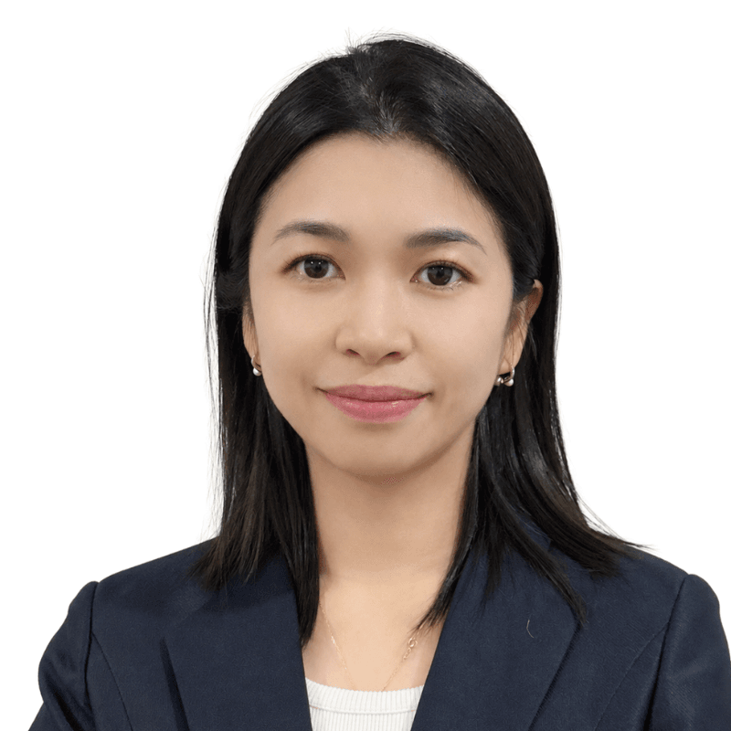 Professional headshot of an Asian woman with shoulder-length black hair, wearing a navy blazer and white top, facing the camera with a slight smile.